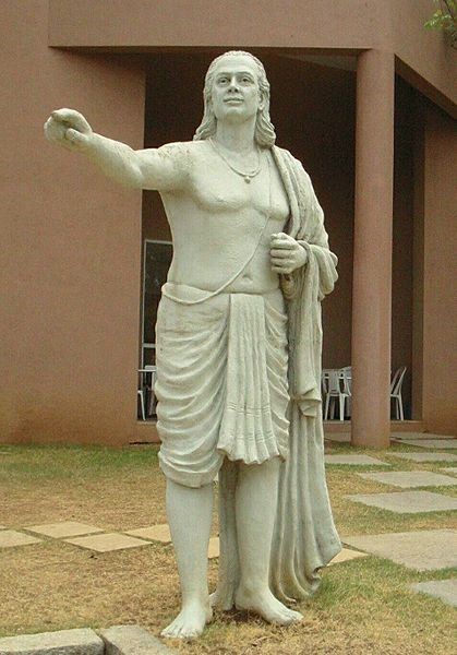 A staute of Aryabhata with one of his fingers pointing to the front.