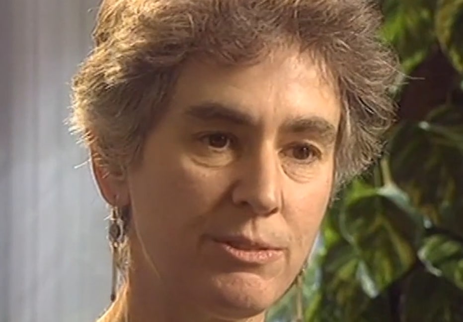 An image showing Jane Wadsworth's head. She has short, grey hair and is wearing long earrings. 