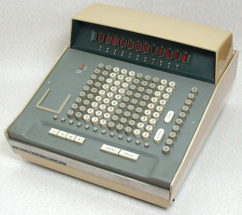 A photograph of an Anita Mk VIII Calculator. It consists of a large grid of buttons, many of which are numbered. It has a protruding number display at its top edge, and is encased in beige coloured metal, with the keyboard coloured grey. 