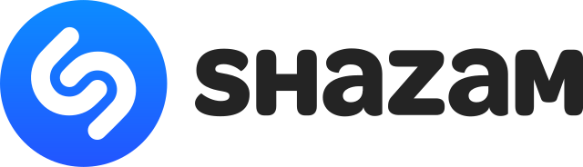The logo of Shazam. It consists of a blue circle and two white angled interlocking U shapes within it. The name Shazam is written immediately to the right of the logo in black writing. 