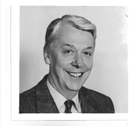 A black and white film photograph of a bust portrait of John Howie. He is wearing a suit facing to the right.